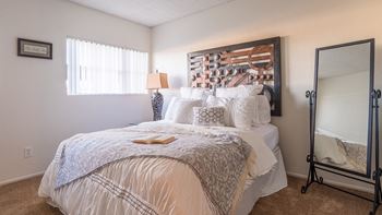 El Encanto master bedroom with nice natural lighting and nice carpet flooring